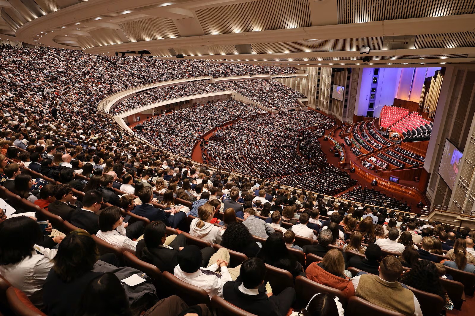 LDS Saints gathering in the Conference Center for General Conference
